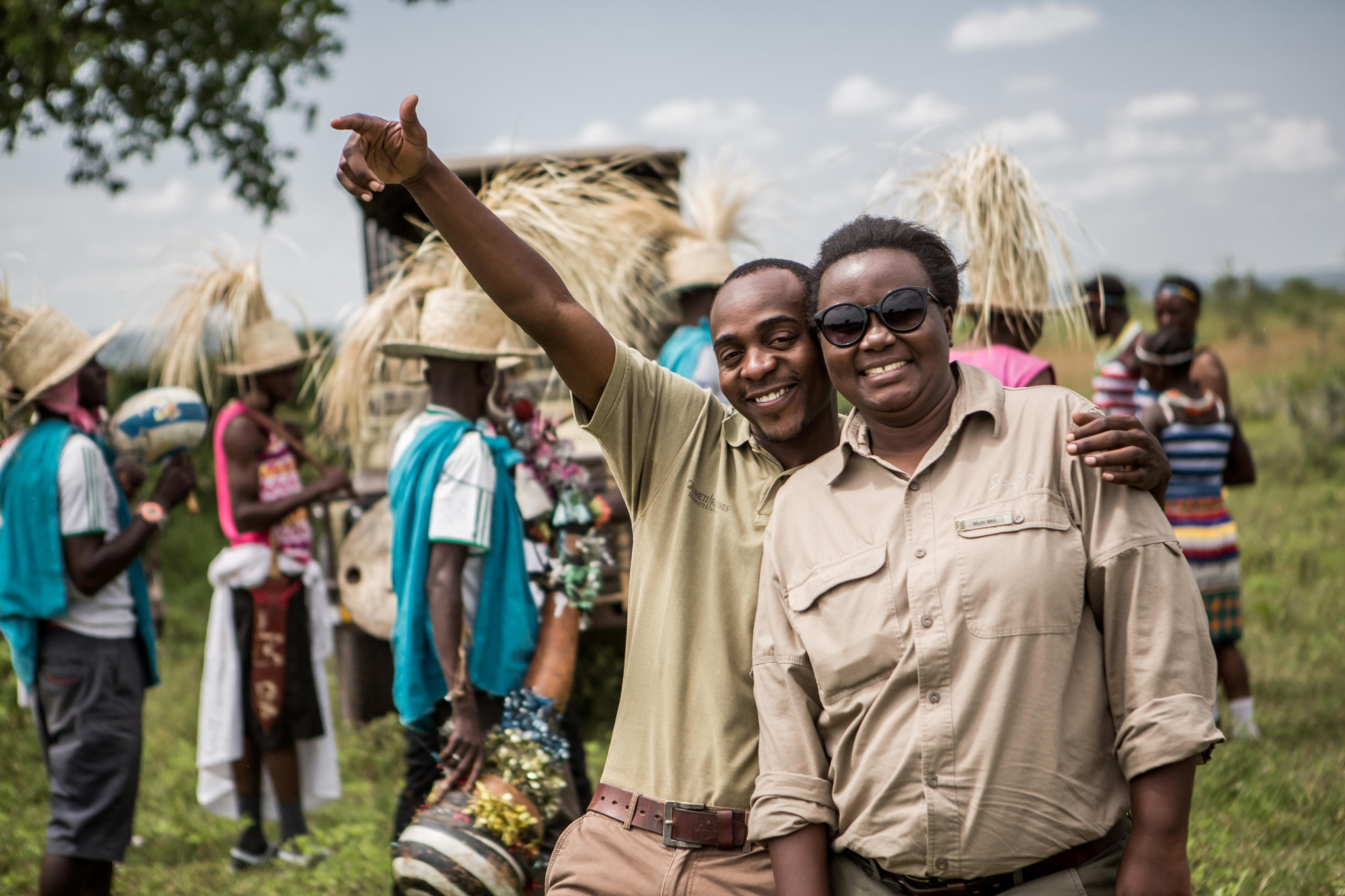 staff on a community visit celebrating at Singita Faru Faru lodge Serengeti