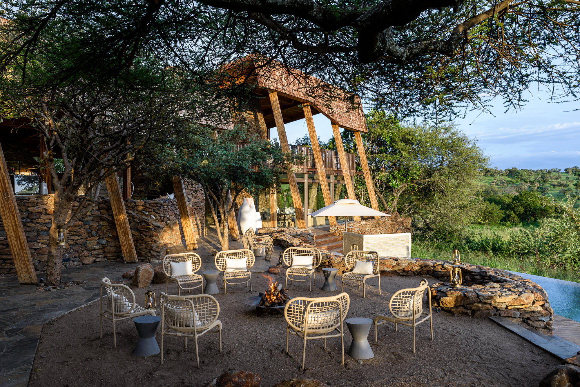 view of the firepit with chairs outside Singita Faru Faru lodge Serengeti