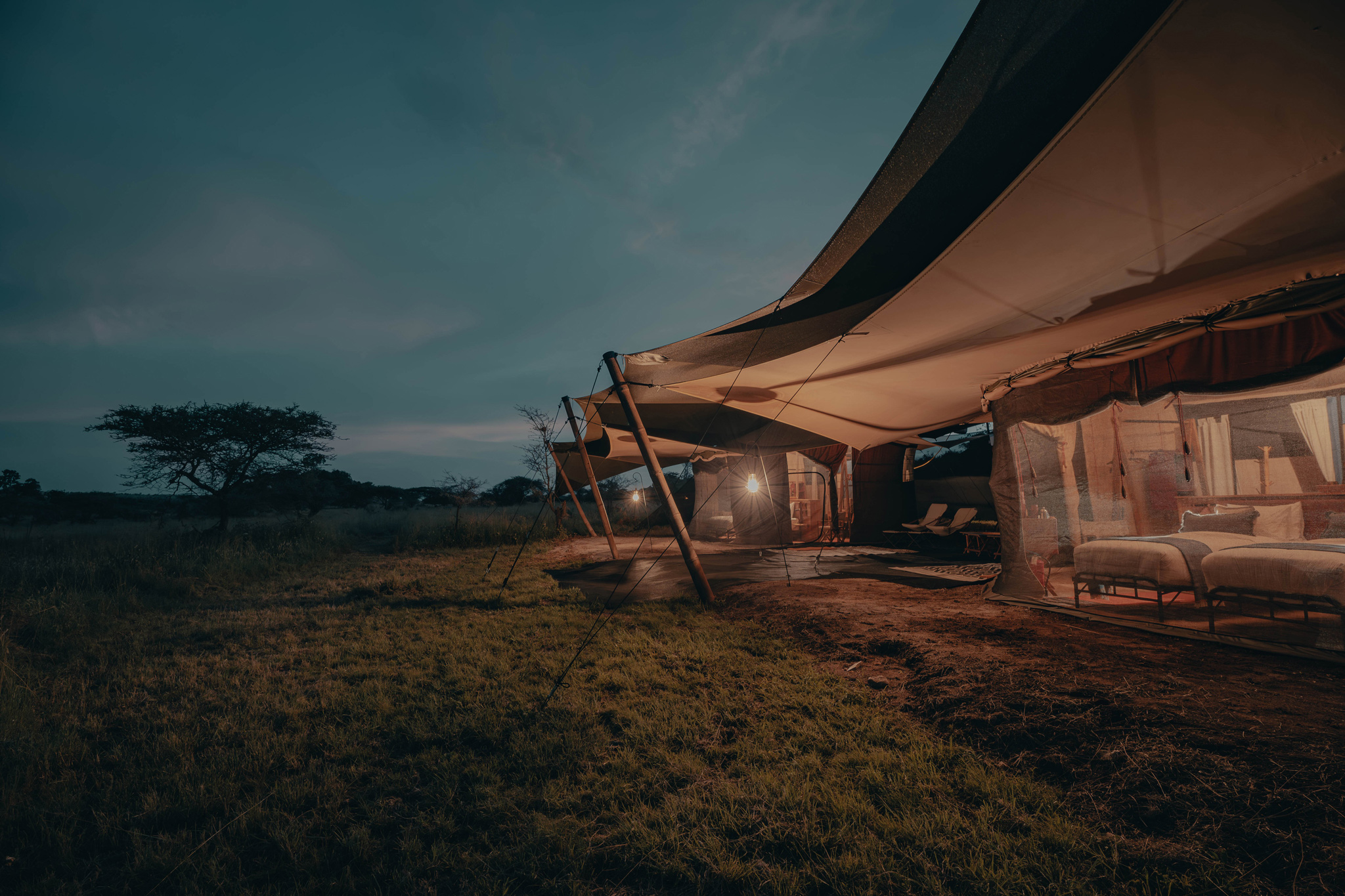 sunset view of the exterior of a tent by Wilderness Usawa tented camp Serengeti